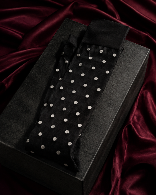 Black polka-dot fashion socks in a Tanzy editorial